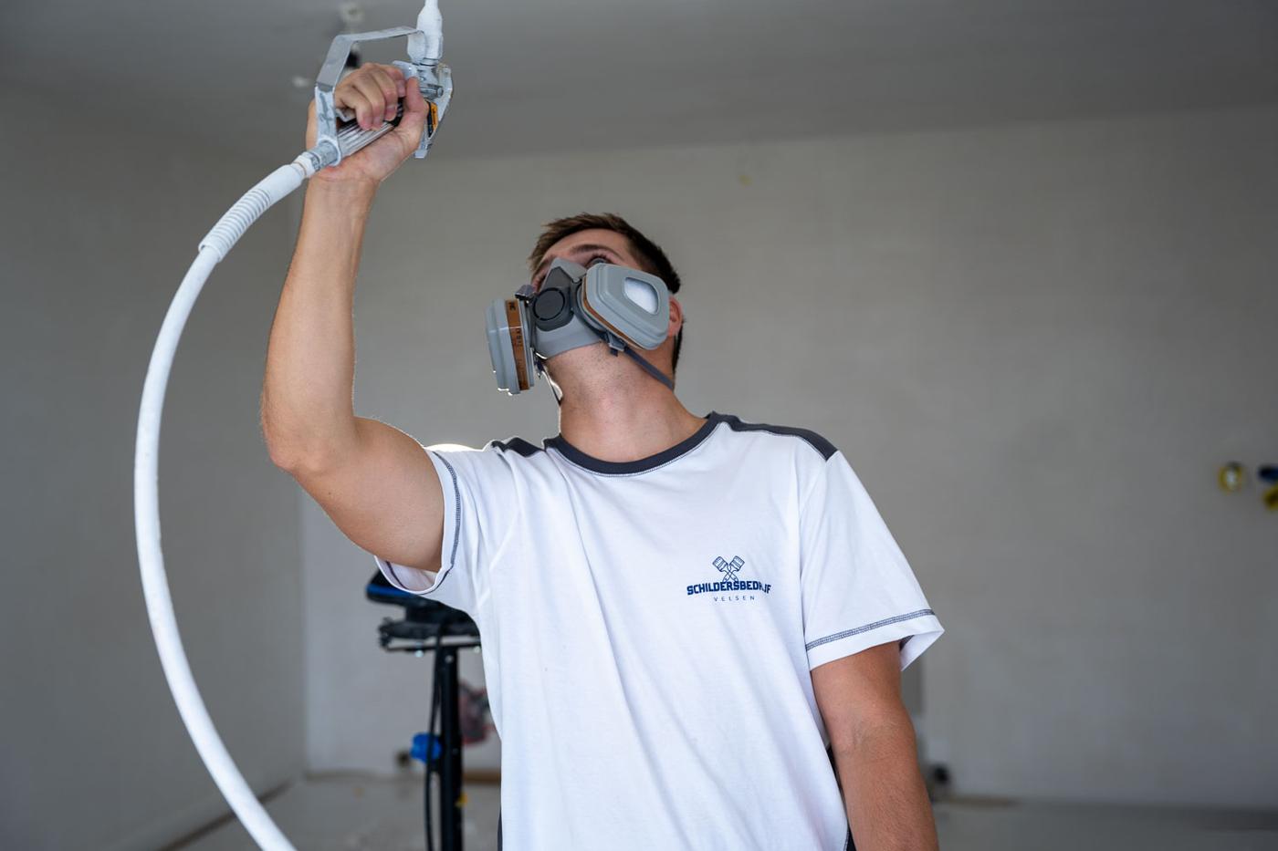 Schilder spuit het plafond